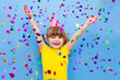 © ulza - happy child girl with confetti on blue background