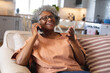 © Wavebreak Media - African american senior woman smiling while talking on smartphone at home