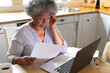 © Wavebreak Media - Stressed african american senior woman using laptop and calculating finances at home