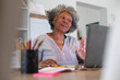 © Wavebreak Media - African american senior woman having a video call on laptop at home