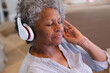 © Wavebreak Media - African american senior woman wearing headphones enjoying listening to music at home