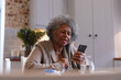 © Wavebreak Media - African american senior woman using smartphone at home