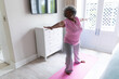 © Wavebreak Media - African american senior woman practicing yoga at home