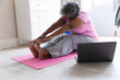 © Wavebreak Media - African american senior woman practicing yoga at home