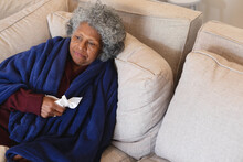 Sick African American Senior Woman Sitting On The Couch