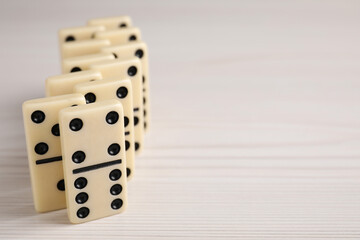 Sticker - Domino tiles on wooden table, closeup. Space for text