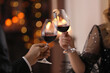 © New Africa - Couple clinking glasses at Valentine's day dinner in restaurant, closeup