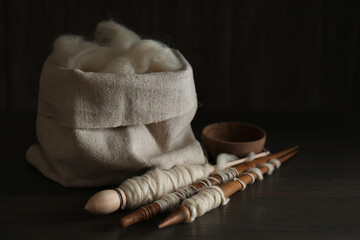 Wall Mural - Soft white wool and spindles on wooden table