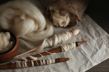 Wall Mural - Soft white wool and spindles on table