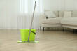 © New Africa - Bucket and mop on floor at home. Cleaning equipment
