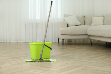 Poster - Bucket and mop on floor at home. Cleaning equipment