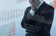 © tadamichi - Recession and declining business performance. Businessperson feeling anxiety and stress. Many graphs.