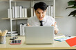 © SHUTTER DIN - young businessman sitting cheering for football on the laptop