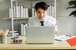 © SHUTTER DIN - young businessman sitting cheering for football on the laptop