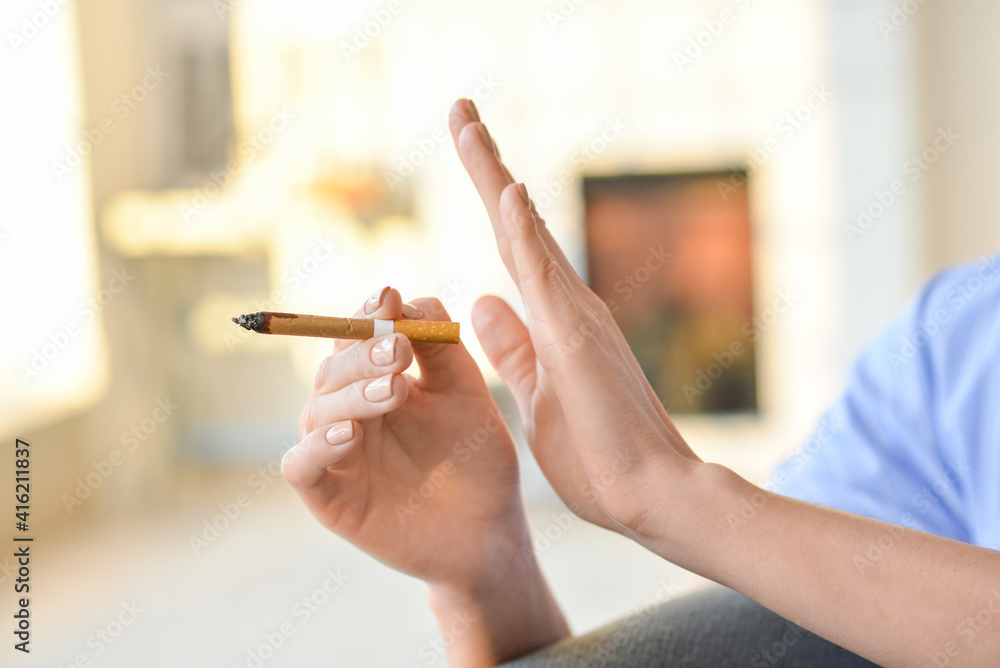 Young woman rejecting cigarette, closeup. Concept of refusing from bad habit