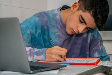 Poster - student at the table writing and studying