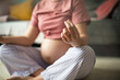 © liderina - Pregnant woman working exercise of yoga at home.