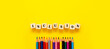© Inga - Inclusion banner word on wooden cubes and pencils on yellow background