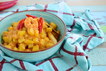 Wall Mural - Sambal goreng kentang udang. Fried cubed potato with prawns cooked with coconut milk and spices (Indonesian food)