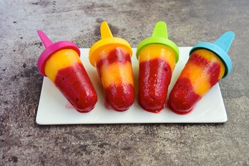 Fresh mango raspberry popsicles. Summer dessert