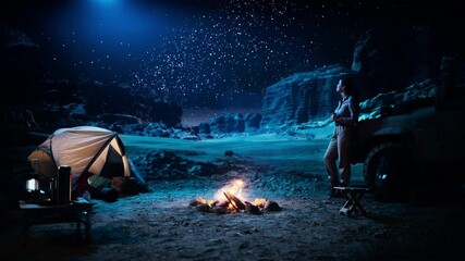 Wall Mural - Female Traveler Watching Night Sky while Camping in the Canyon by Campfire. Amazing Campsite view of Milky Way Stars with Traveling Woman Adventurer on Inspirational Nature Loving Journey