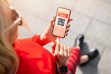 Woman viewing discount coupon on mobile phone