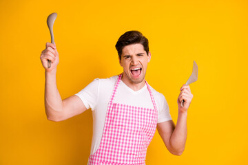 Sticker - Photo portrait of crazy carefree man dancing with kitchenware isolated on vivid yellow colored background