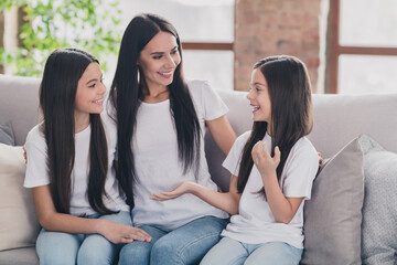 Canvas Print - Portrait of beautiful cheerful girls best friends talking spending day sitting on divan at house flat apartment indoors