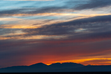 Wall Mural - Fiery sunset in the mountains in Mojave California
