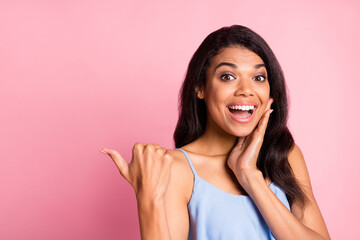 Poster - Photo of impressed brunette lady point empty space hand face wear blue top isolated on pink color background