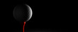 © Yingyaipumi - Sport and spirit concept.Close Up white golf ball on a black background.Golf ball on red tee on dark background.copy space and Panoramic banner.