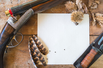 Wall Mural - Beautiful hunting still life. Vintage hunting gun, pheasant feathers and hunting knife on old wooden background. Top view