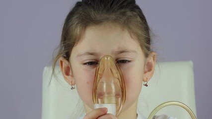 childhood asthma inhaling mask illnesses little baby girl with flu id doing aerosol independently . 