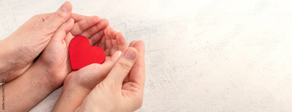 Children and mothers hands holding red heart on white textured background. Concept of health care, love, organ donation, mindfulness, wellbeing, family insurance - obrazy, fototapety, plakaty 