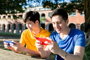 Wall Mural - young students use smartphone