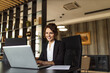 © bnenin - Successful businesswoman working on laptop, portrait.