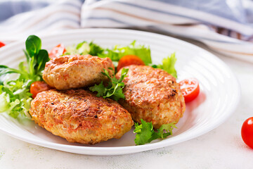 Wall Mural - Meatballs with cabbage. Lazy cabbage rolls with fresh salad on light background. Russian cuisine.