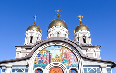 Poster - Mosaic icon on the wall and golden domes of the temple