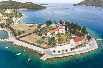 Wall Mural - Aerial drone shot of St. Jeronima church on Vis Island coastline by adriatic sea in summer