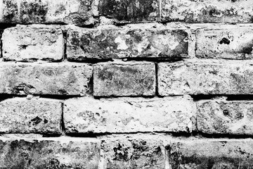 Texture of a brick wall with cracks and scratches which can be used as a background