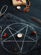 the ritual of black magic, the concept of occultism, a drawn pentagram on a blackboard, an old spellbook