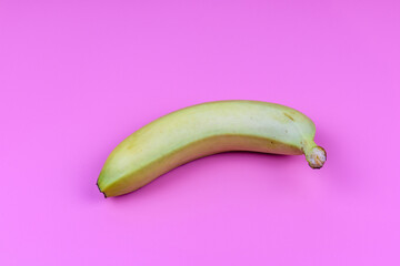 Wall Mural - Whole yellow banana isolated on a pink background