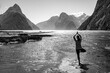 Athletic female practicing yoga outdoors, Milford Sound, New Zealand