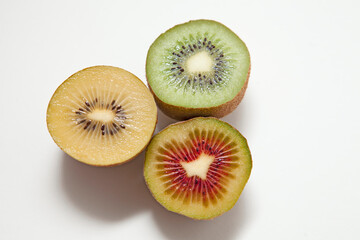 Kiwi Fruits in three different colors: Red Kiwi, Gold Kiwi and Green Kiwi isolated on white background. 