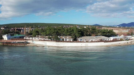 Wall Mural - Aerial view of Divnomorskoe small sea resort town on Black Sea coast, beautiful seascape in sunny day.