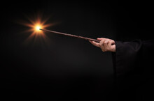 Magic Wand With Sparkle, Miracle Magical Wand Stick With Light Sparkle. Teens Hand Holding A Wand Wizard Conjured Up In The Air.