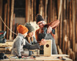 © JenkoAtaman - Kid with parents assembling wooden bird house in craft workshop