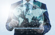© tadamichi - Global business and network technology. Business person using tablet computer. Network structure and world map.