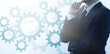 © tadamichi - Thinking businessperson and many blue gears. Logical thinking concept image.