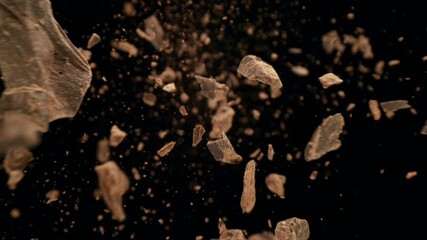 Poster - Super slow motion of falling group of raw chocolate pieces on black background. Filmed on high speed cinema camera, 1000fps.
